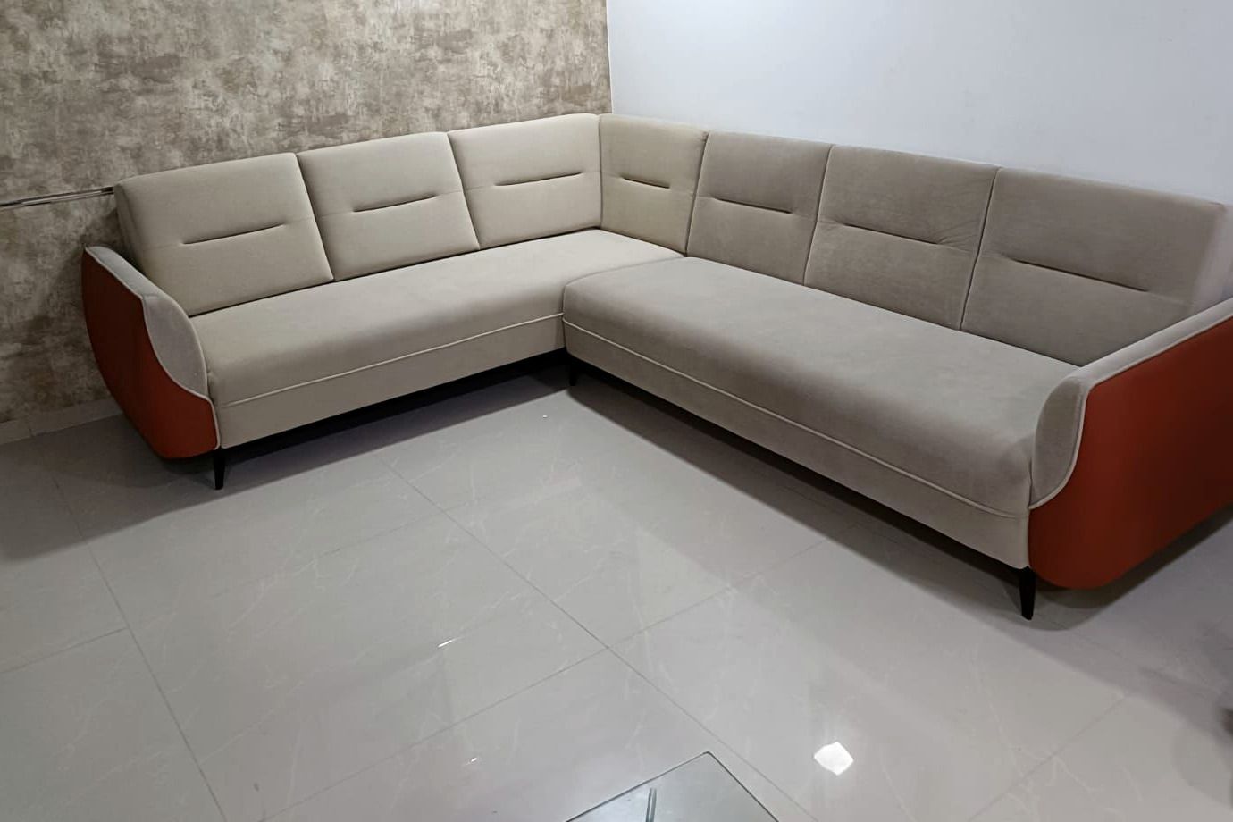 Sand-coloured L-shaped corner sectional with rust outer panels.