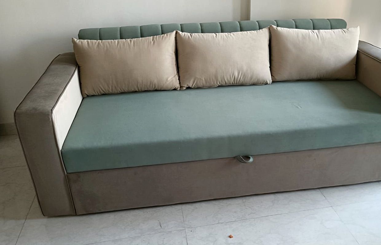 Sage and taupe sofa bed with a bench seat and storage base.