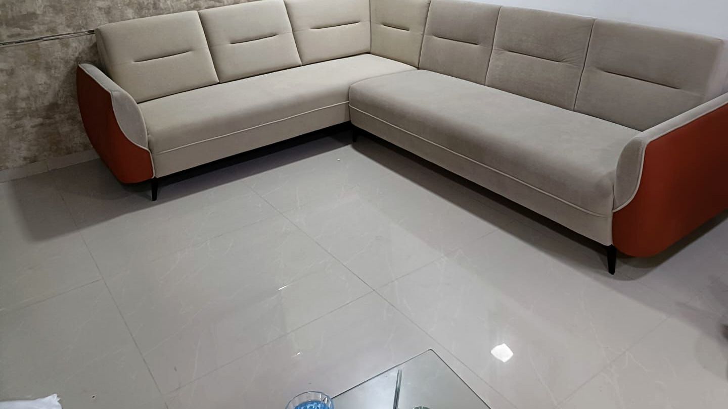 Corner sectional in a bright tiled room.